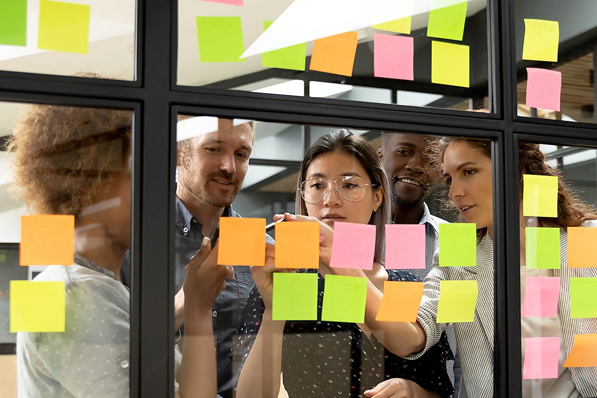 team working with post its