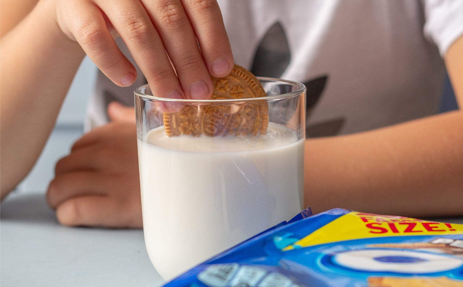 child dunking Oreo cookie