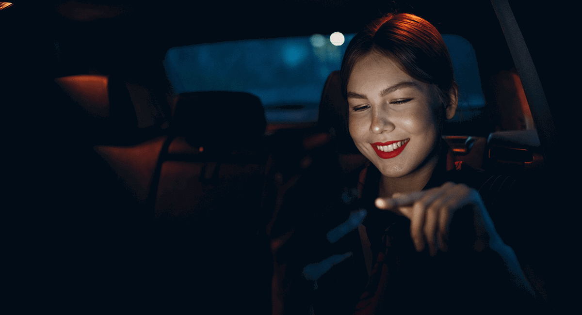 Woman on her phone in car