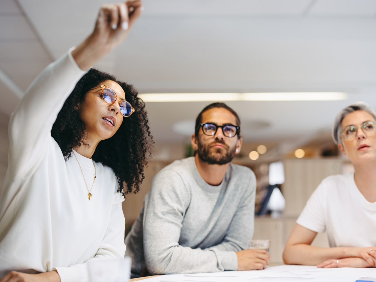 Diverse three person team engaged in a meeting Valtech