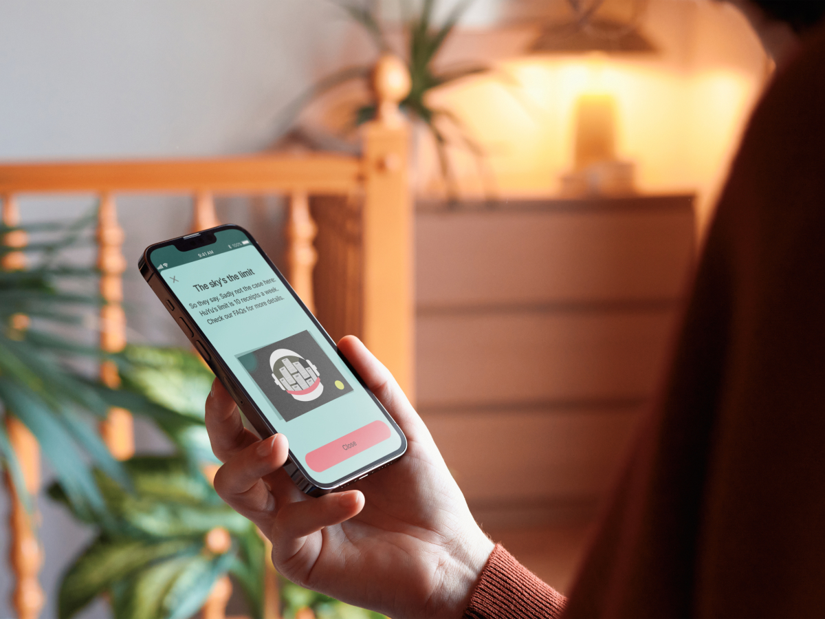  A person is holding a smartphone and viewing a screen with the title "The Sky's the limit!"