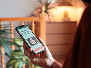 A person is holding a smartphone and viewing a screen with the title "The Sky's the limit!"