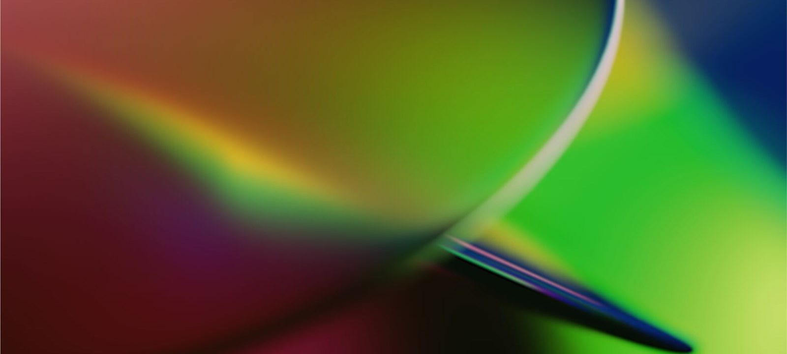 An abstract image featuring a smooth blend of vibrant colors, including green, yellow, purple, and red. The colors transition seamlessly, creating a gradient effect with soft, curved lines. The design has a dynamic, fluid feel, evoking a sense of motion and energy. The image is visually striking, with a modern and futuristic aesthetic, suitable for representing innovation or creative concepts.