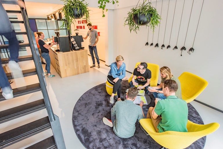 Group of people sitting and chatting around a round table