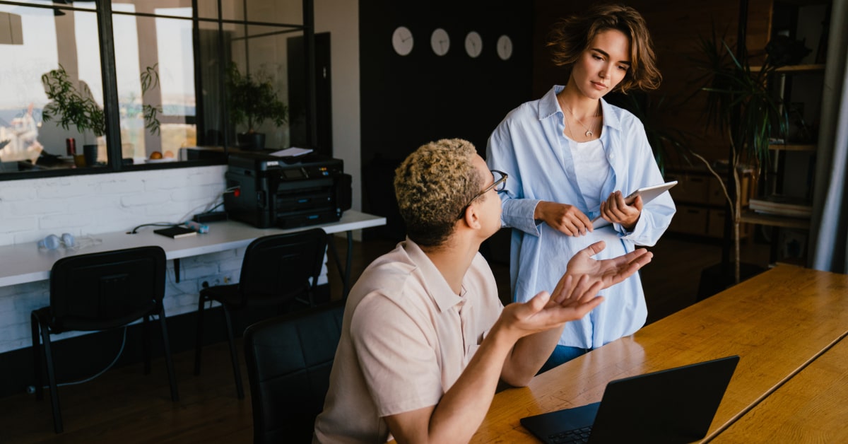 Two coworkes in conversation.