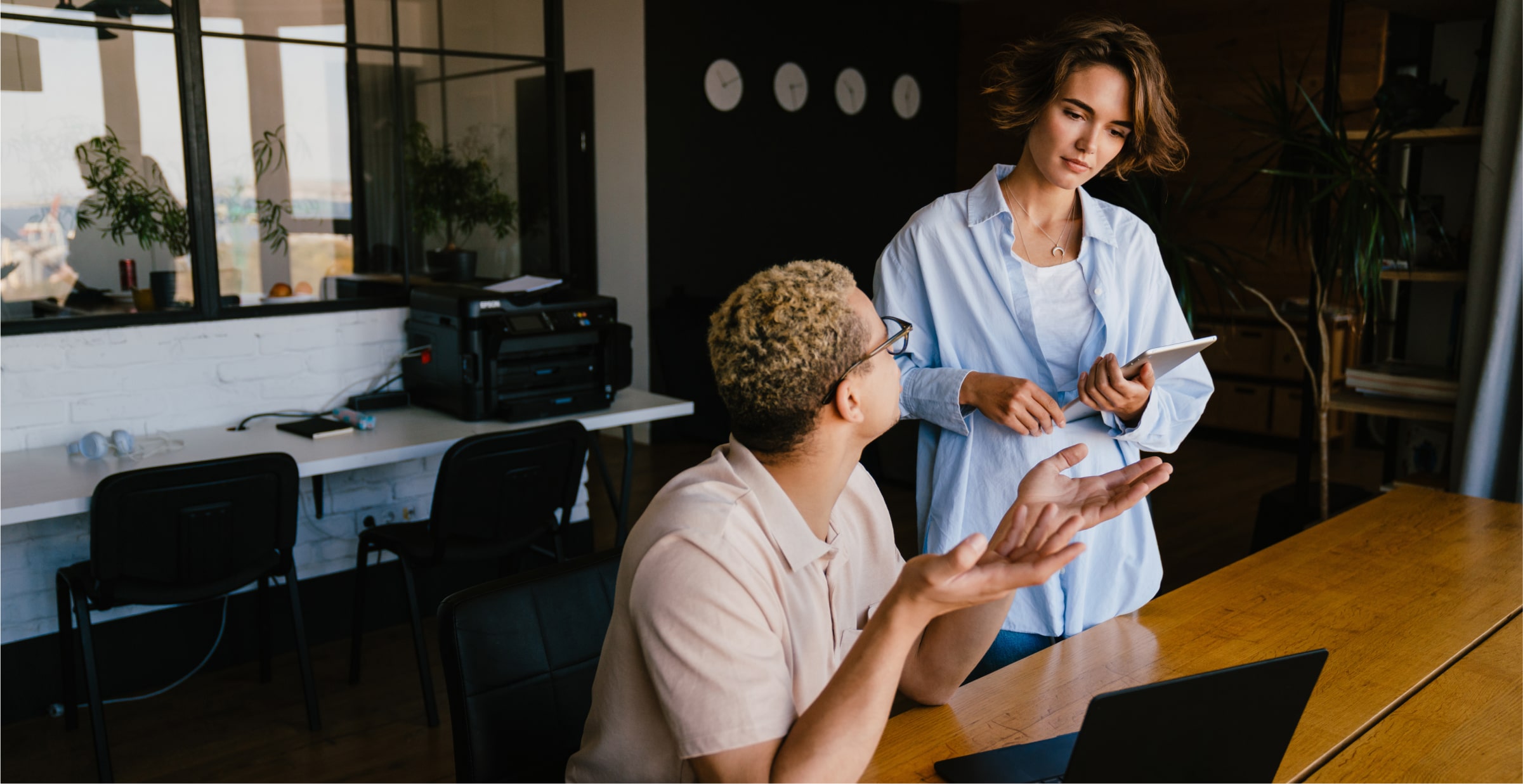 Two coworkes in conversation.