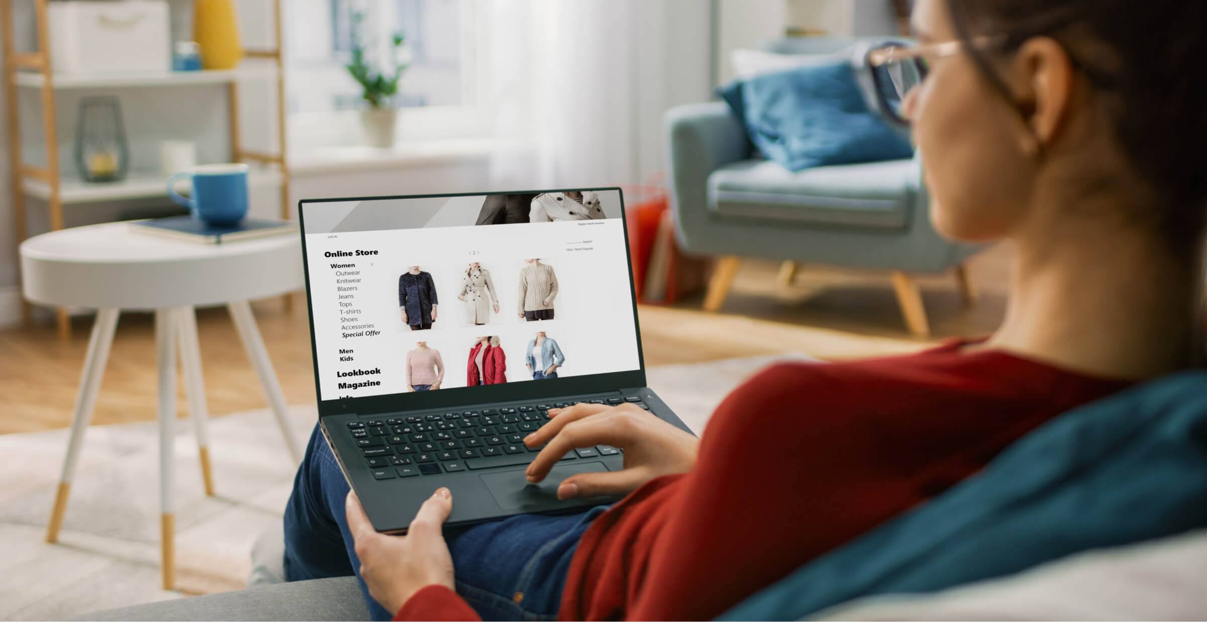 Woman browsing an online clothing store on a laptop at home.