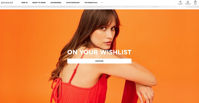 Orange background with woman sitting in centre smiling at camera