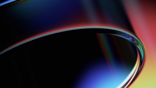 An abstract image featuring smooth, curved shapes with a gradient of vibrant colors including blue, red, and yellow, creating a sleek and dynamic visual effect.