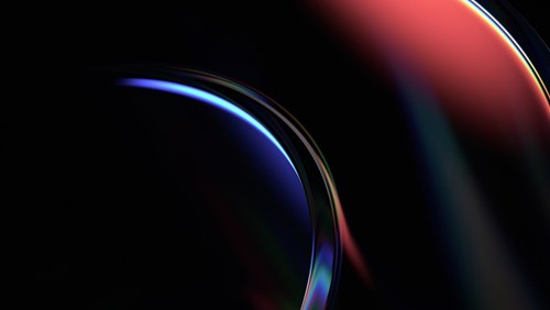 An abstract image featuring smooth, curved shapes in a dark background, illuminated by a blend of deep blue and red hues. The glossy, reflective surface of the shapes adds a sense of depth and dimension, with the colors softly transitioning from one to the other. The light accents highlight the curvature, creating a sleek, futuristic feel. The dark setting enhances the vibrancy of the colors, giving the image a dynamic and modern look, often associated with technology, data, and innovation.